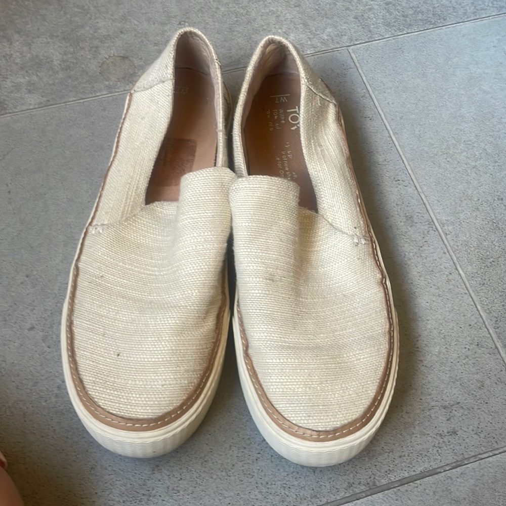 Toms beige slip on shoes.